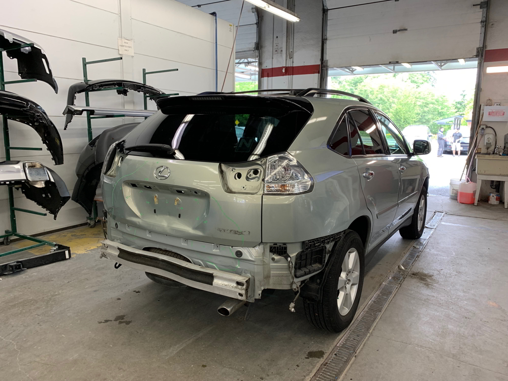 Back end of a Lexus SUV being repaired at Maximum Collision