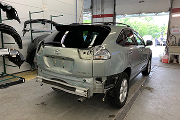 Small image of a Lexus SUV being repaired at Maximum Collision